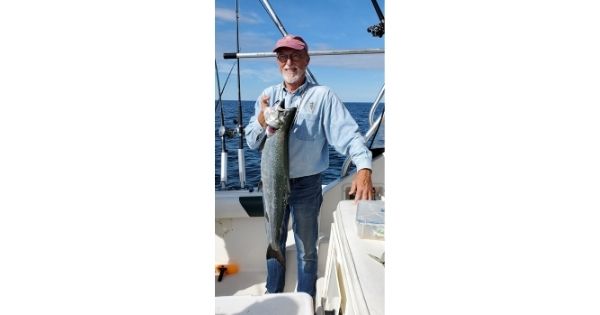 Jim Wilson, CEO, holding a fish