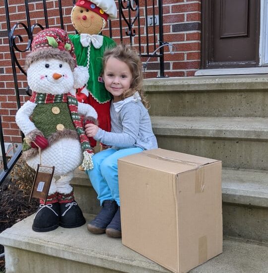 Box Latch - Girl on steps with stuffed snow man and corrugate box